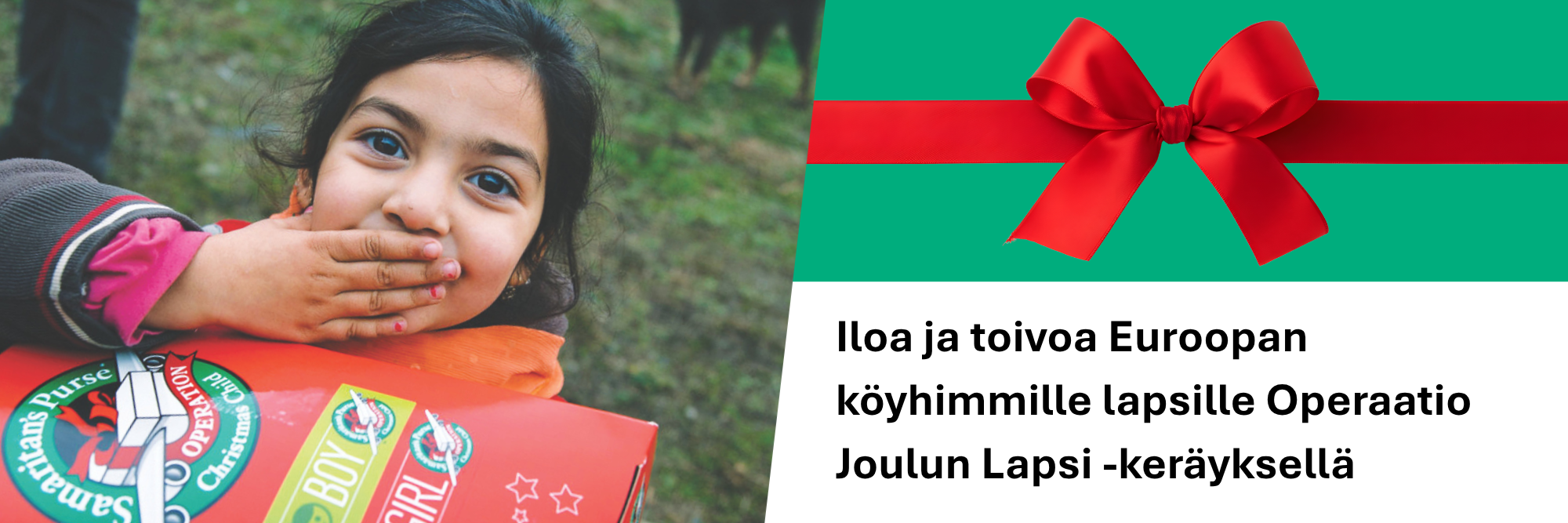 Lapsi punainen lahjapaketti sylissä.
