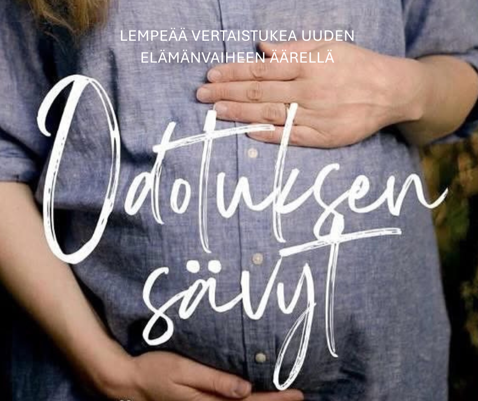 Odottava äiti pitää käsillään vatsaa